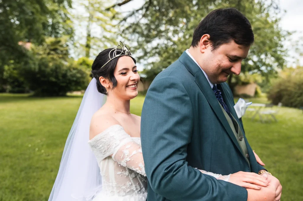La mariée enlace son marie pour lui donner les mains.