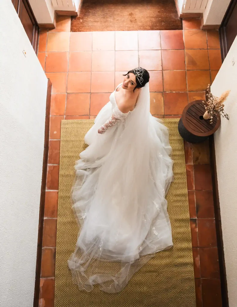 La mariée en contrebas regarde le photographe de mariage à Toulouse qui doit lui donner le top départ avant qu'elle puisse retrouver son mari pour la séance photo du first look